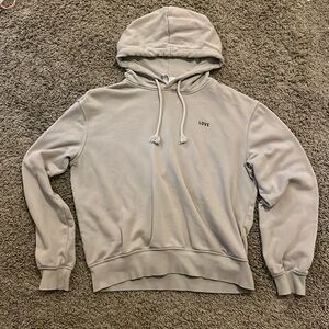 tan sweatshirt that says love on it